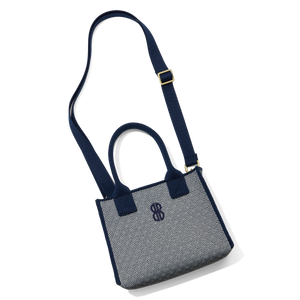 Madison Mini Handbag lying on the floor with a shoulder strap attached