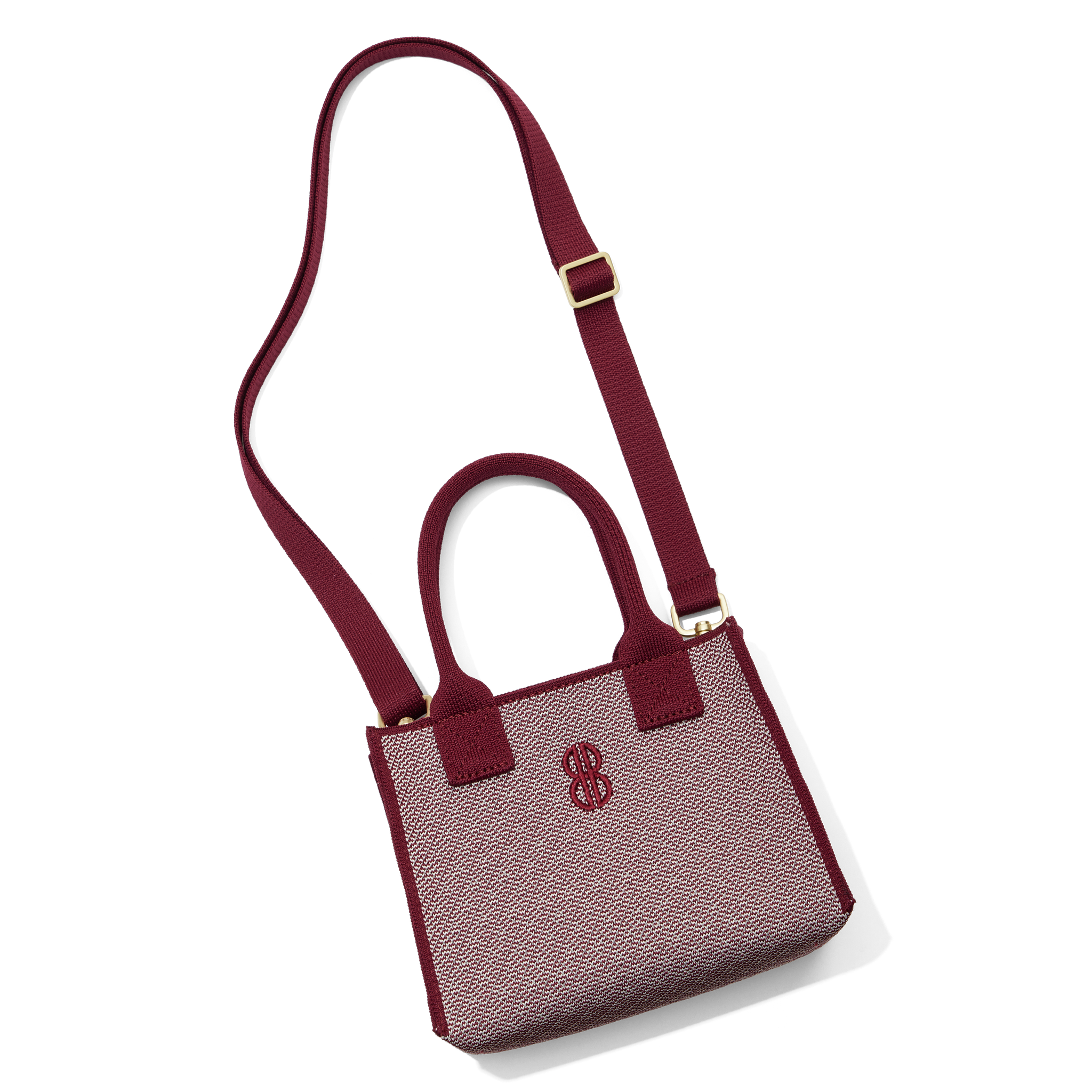 Madison Mini Handbag lying on the floor with a shoulder strap attached