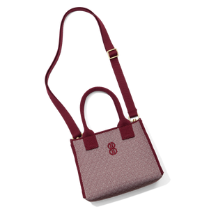 Madison Mini Handbag lying on the floor with a shoulder strap attached