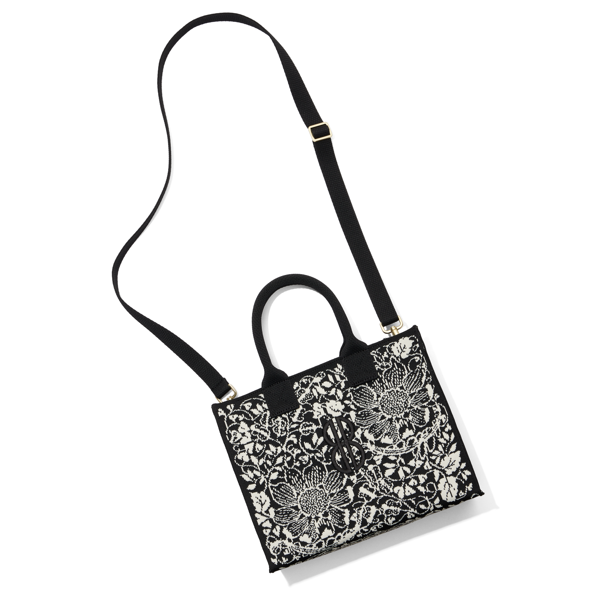 Madison Small Handbag lying on the floor with a shoulder strap attached