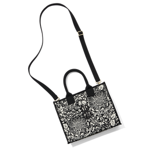 Madison Small Handbag lying on the floor with a shoulder strap attached