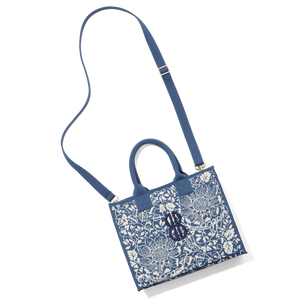 Madison Small Handbag lying on the floor with a shoulder strap attached