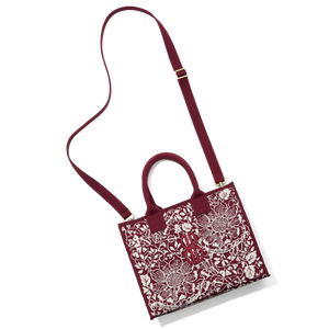 Madison Small Handbag lying on the floor with a shoulder strap attached