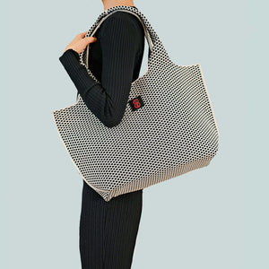 Black Diamond tote draped over shoulder