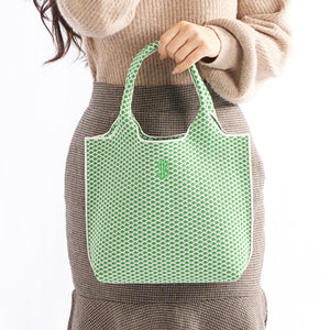 Sutton City Tote - Parakeet Green Diamond held by a hand