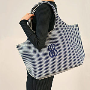 Sutton City Tote - Navy Diamond Monogram draped on shoulder