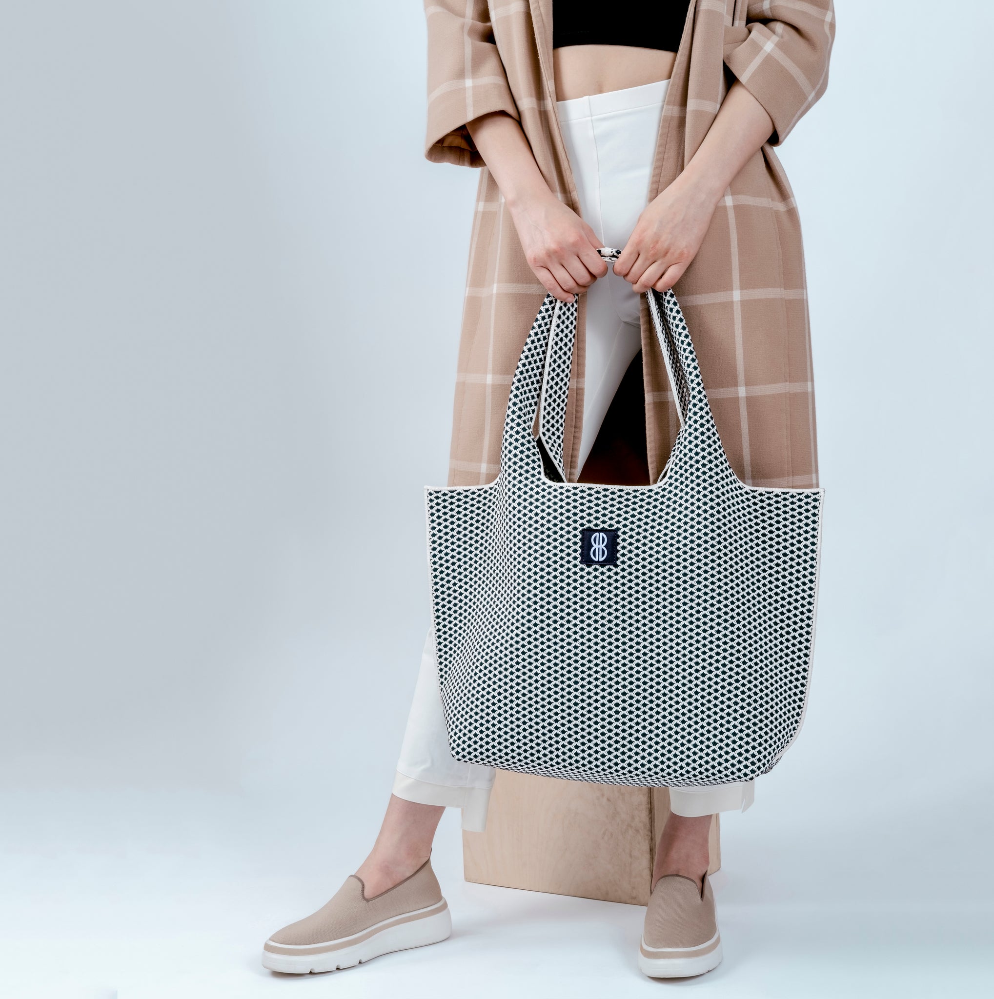 Navy Diamond tote held by hands