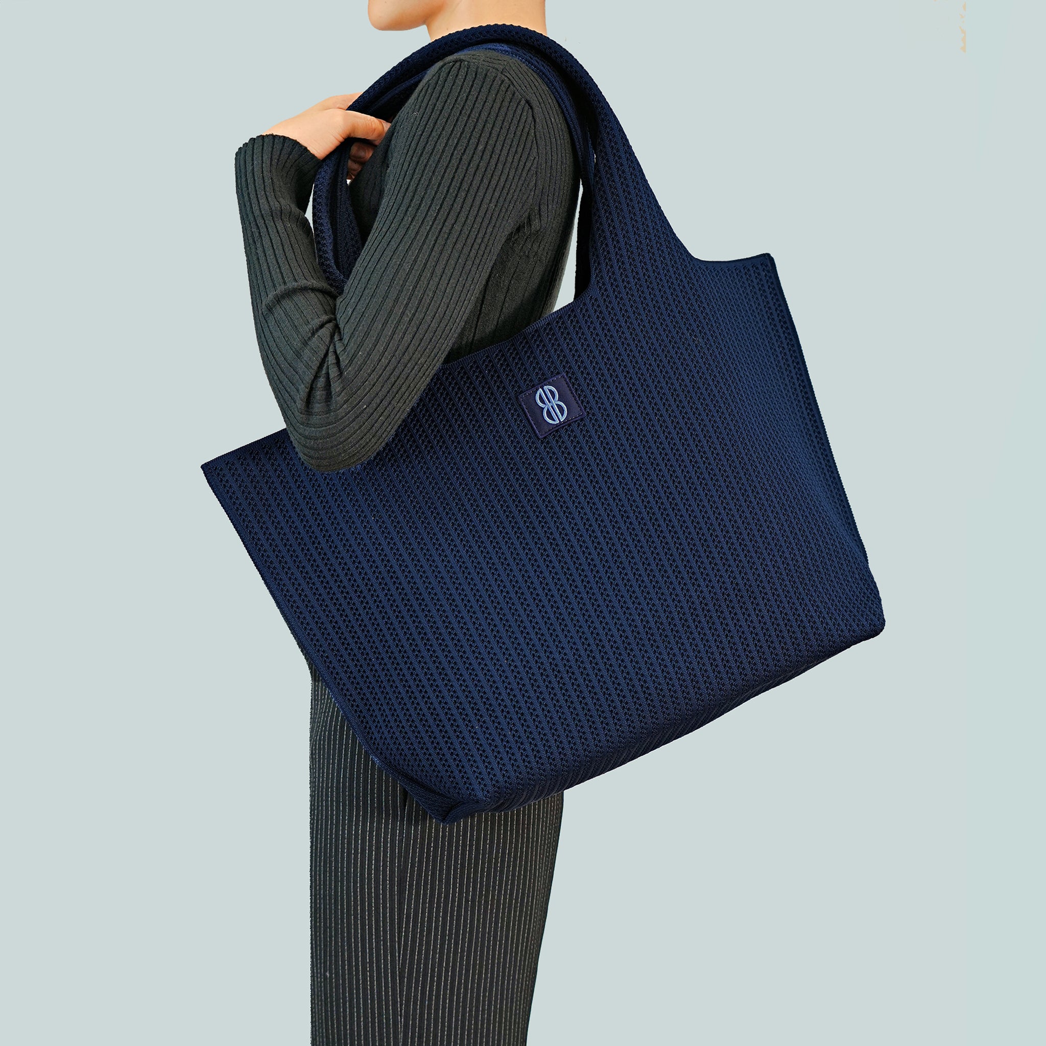 Navy Stripe tote draped over shoulder