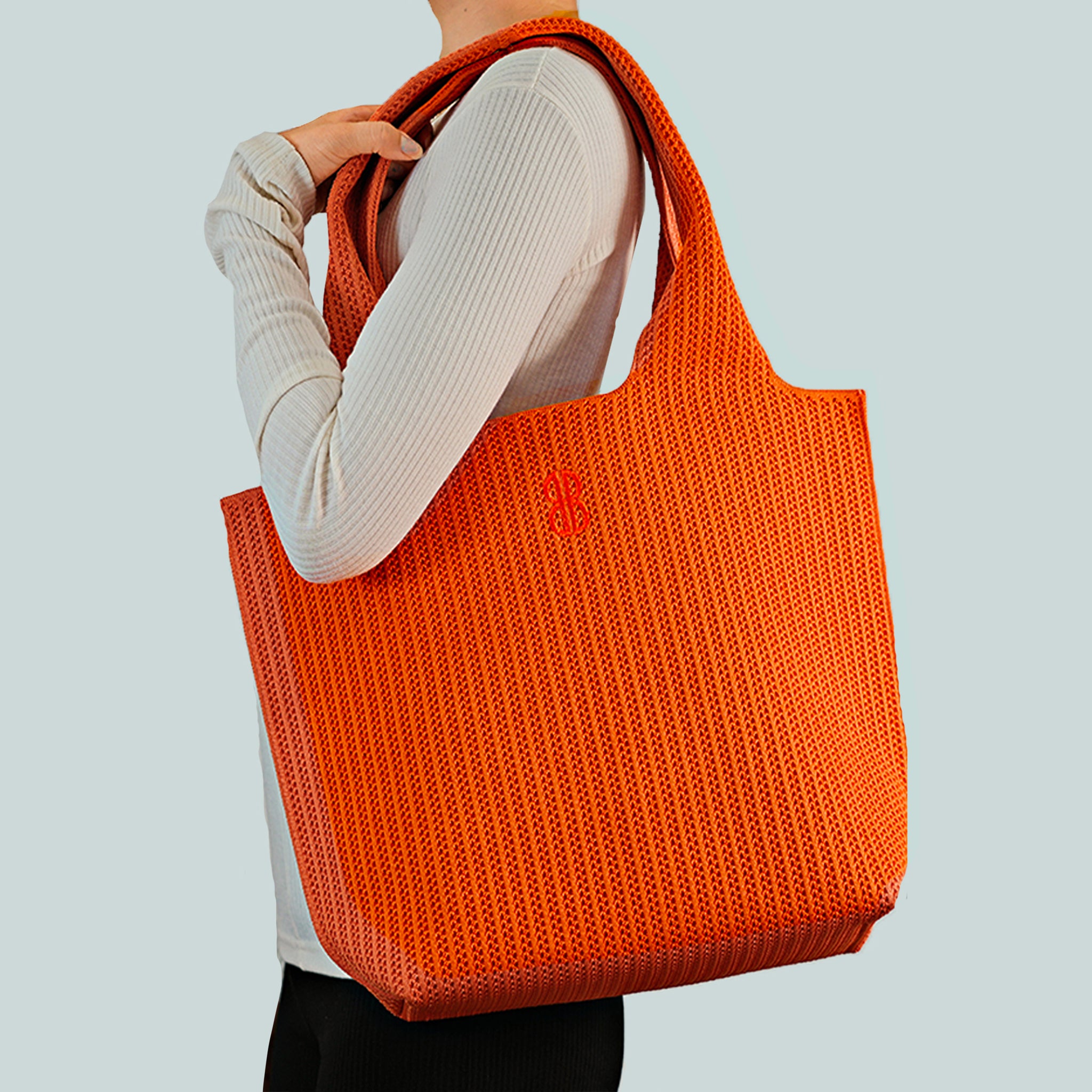 Sutton City Tote - Orange Stripe draped on shoulder