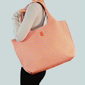 Sutton City Tote - Orange Diamond draped on shoulder