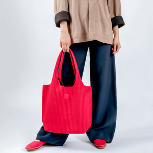 Red Stripe Tote held by hand